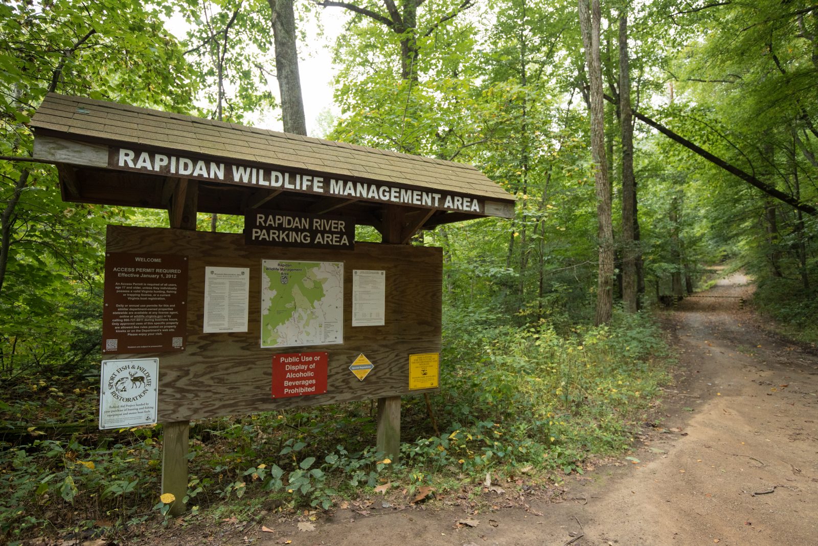 A kiosk at Rapidan Wildlife Management Area and a dirt path leading into the area